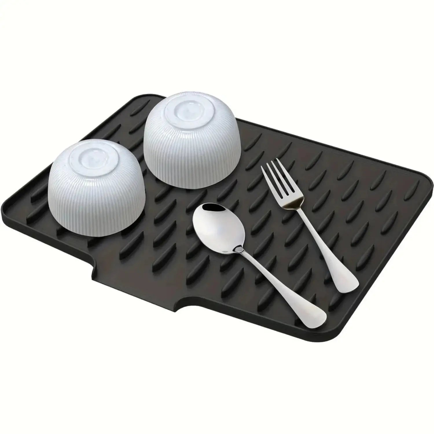 Black rubber mat with white bowls, spoon, and fork on a white background